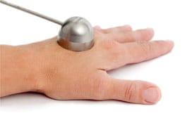 Valencia applicator, which is used with isotope based brachytherapy, positioned on a hand